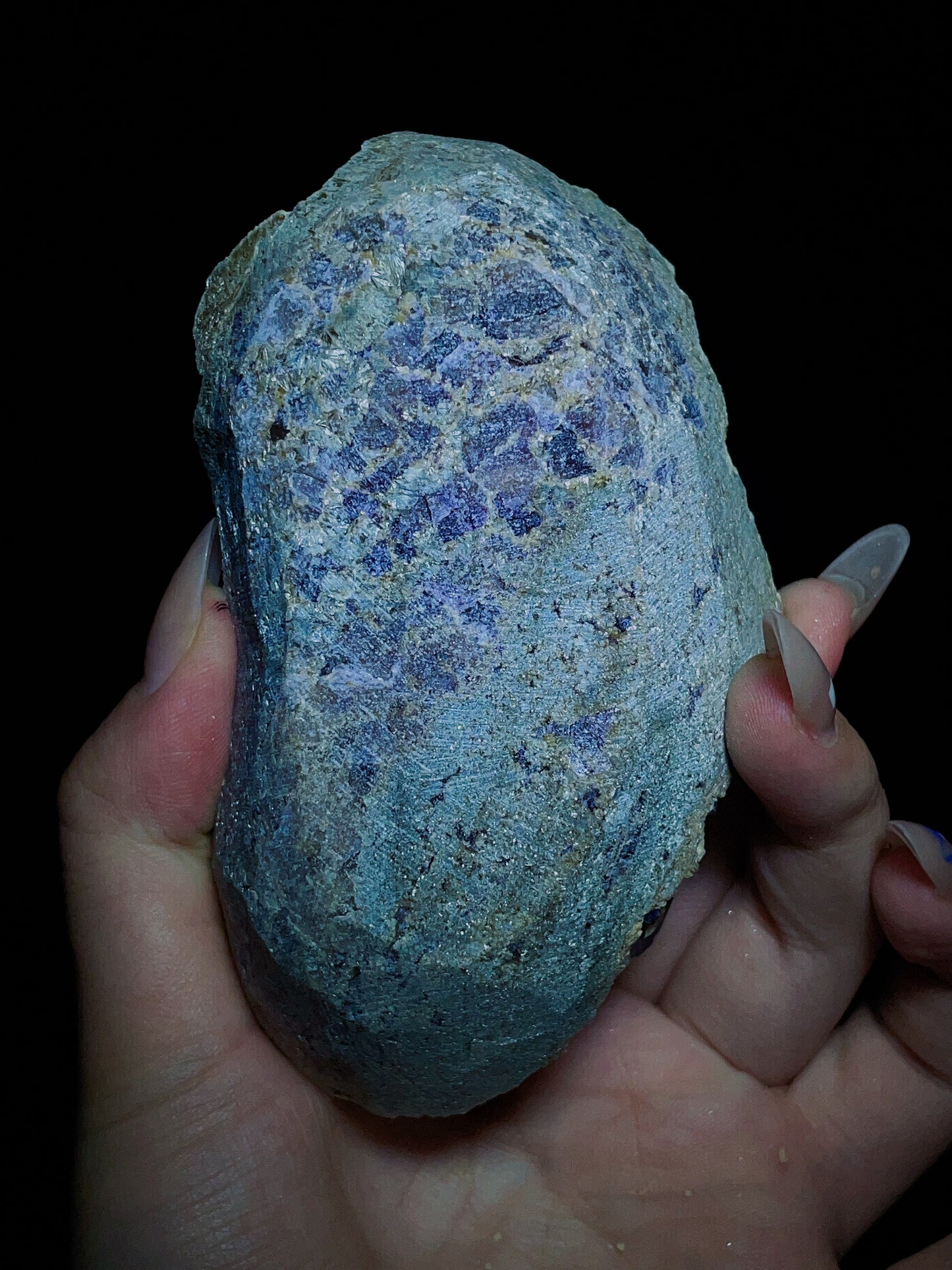 Dark purple-black fluorite associated with spherical matrix from Chifeng, Inner Mongolia, China.