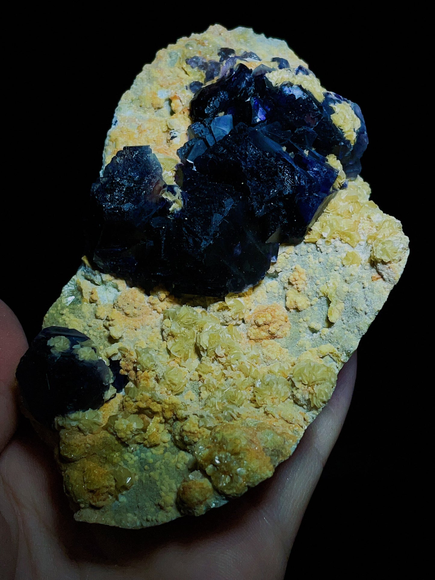 Dark purple-black fluorite associated with spherical matrix from Chifeng, Inner Mongolia, China.