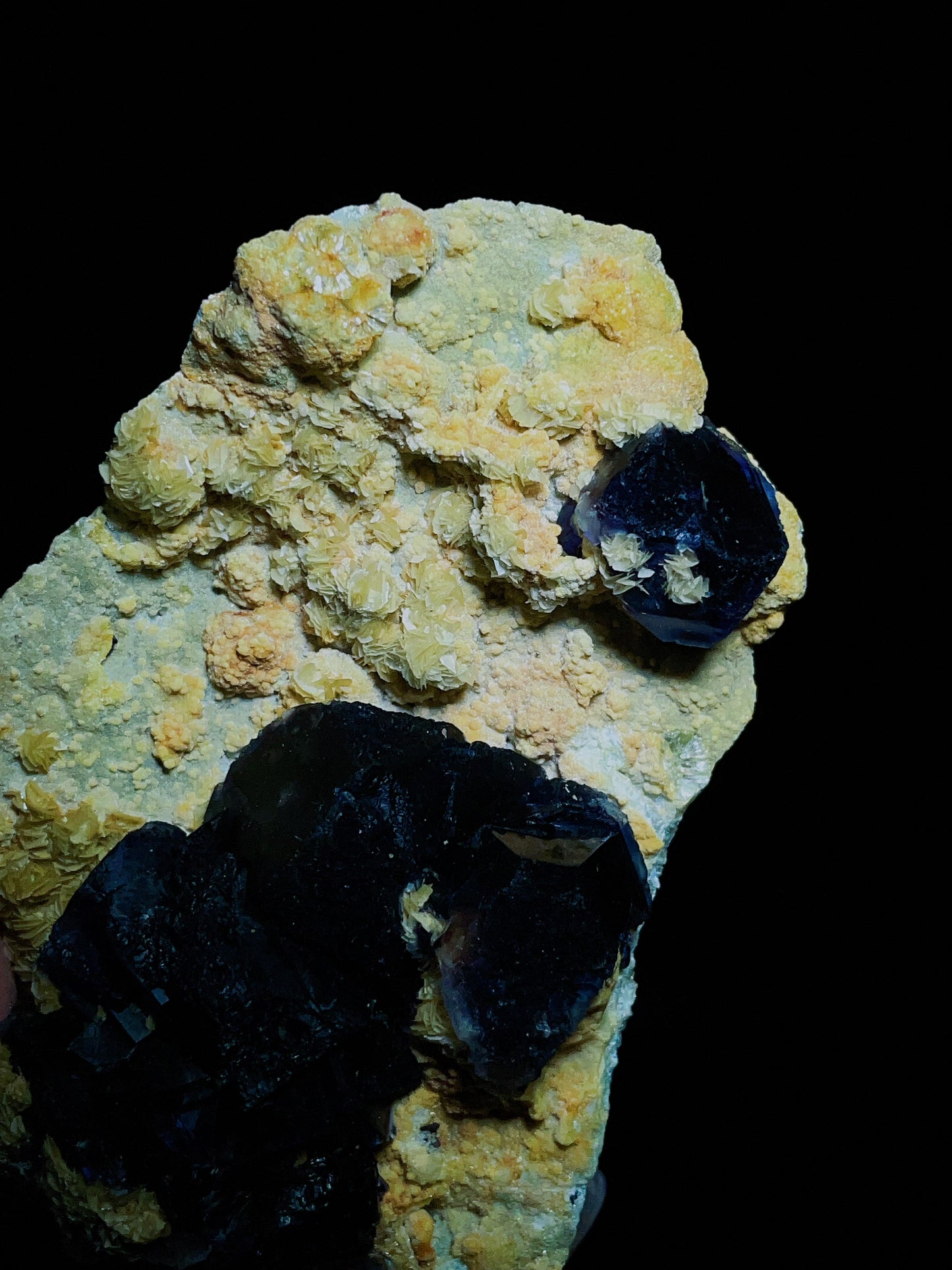 Dark purple-black fluorite associated with spherical matrix from Chifeng, Inner Mongolia, China.
