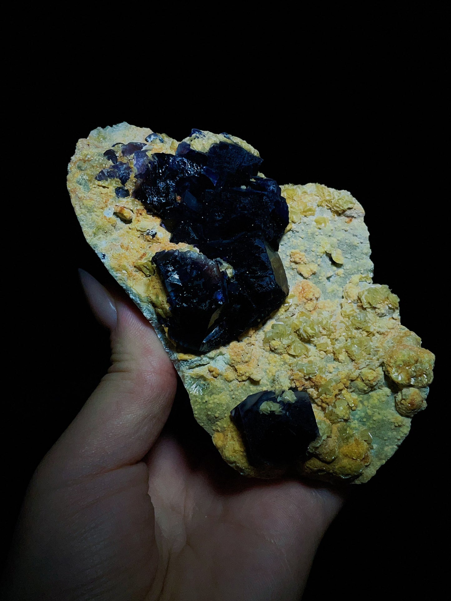 Dark purple-black fluorite associated with spherical matrix from Chifeng, Inner Mongolia, China.