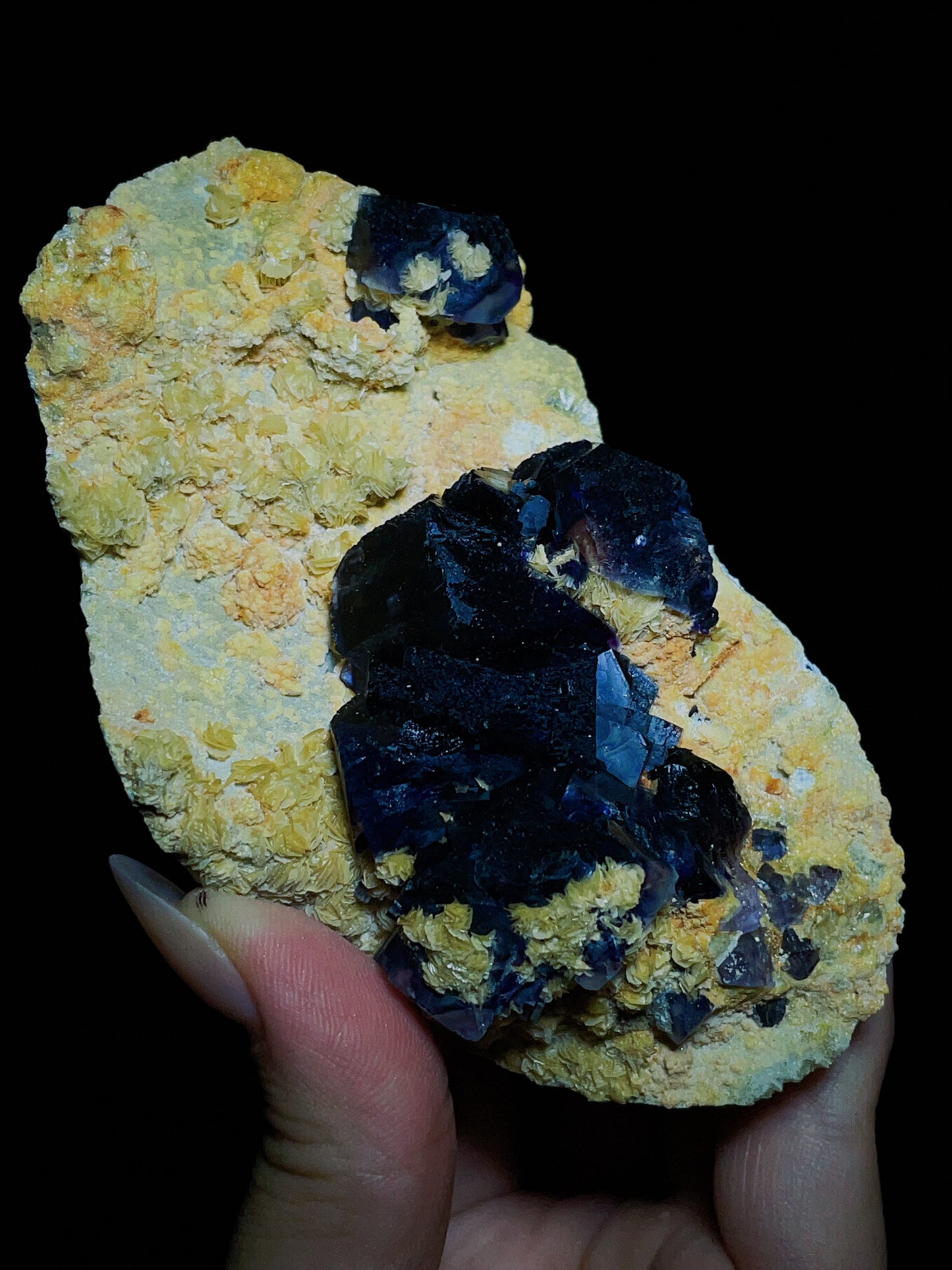 Dark purple-black fluorite associated with spherical matrix from Chifeng, Inner Mongolia, China.